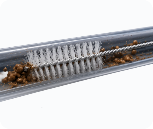 A conventional cleaning brush inside an endoscope channel, leaving debris and residue on the walls
